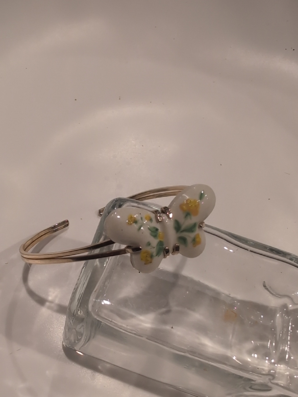 Avon Gold-Tone Open Cuff Bracelet with White Butterfly and Yellow Floral Detail